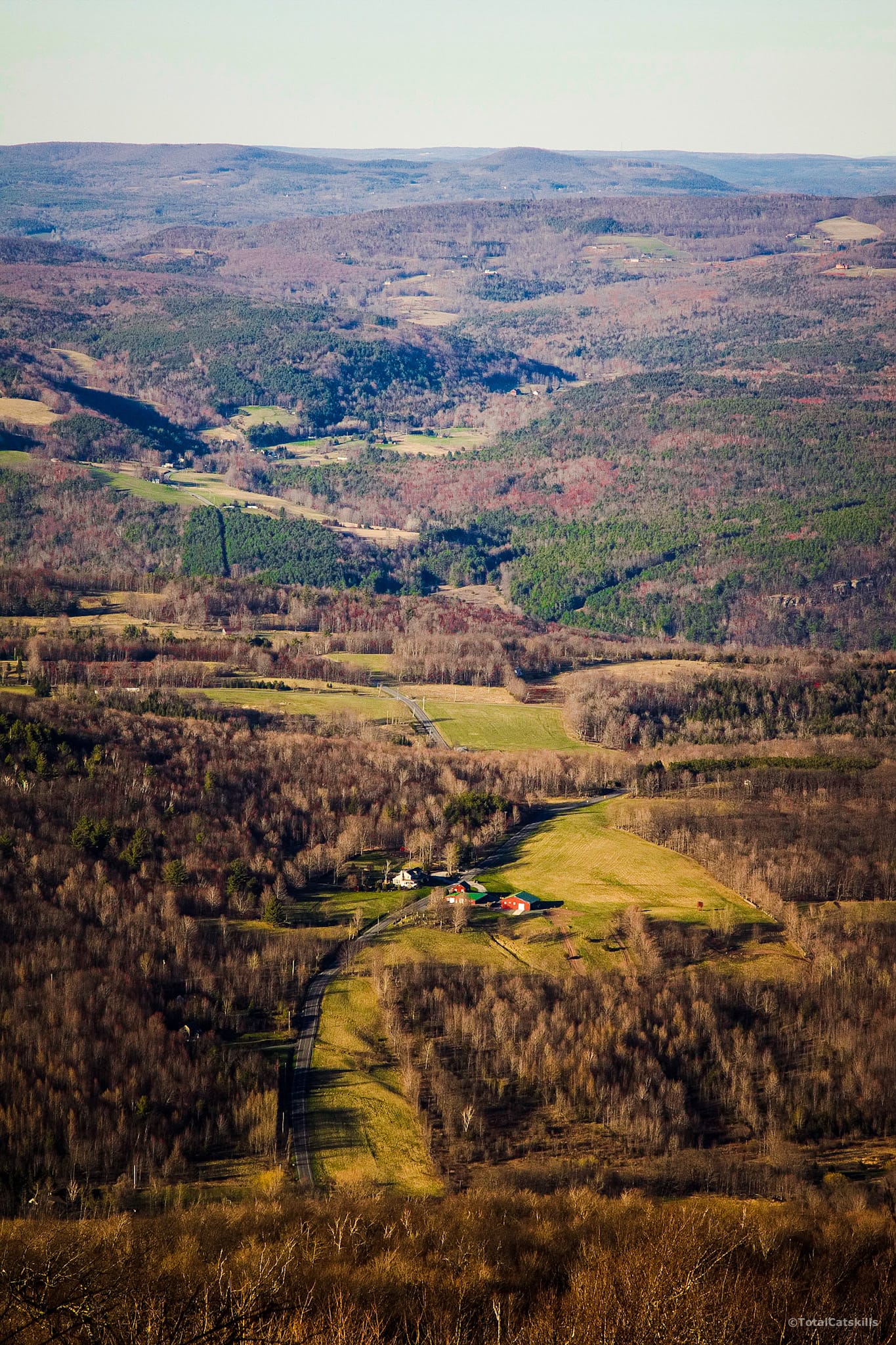 scenic photograph of valley with farmhouses