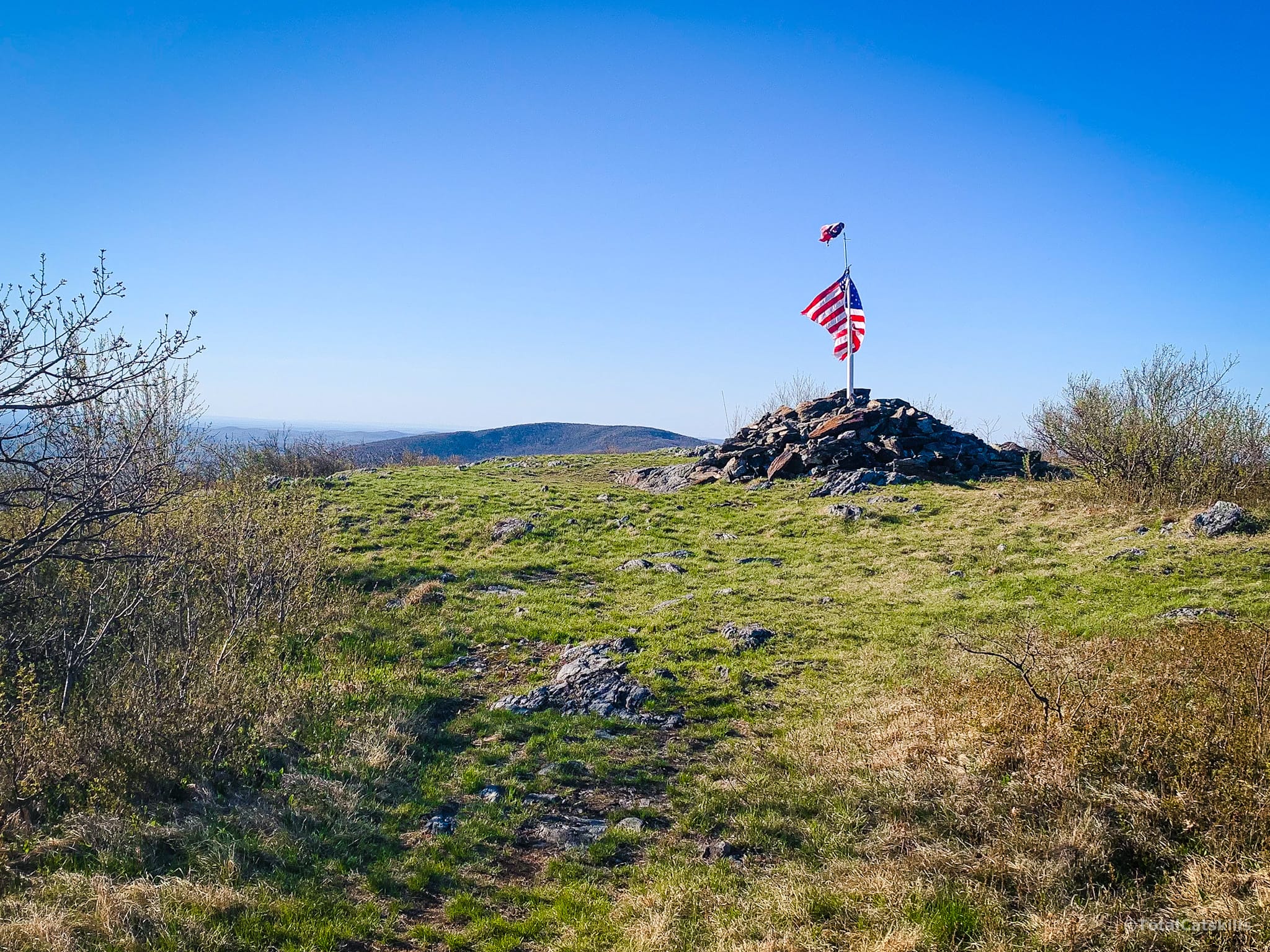 american flag on summit cairn