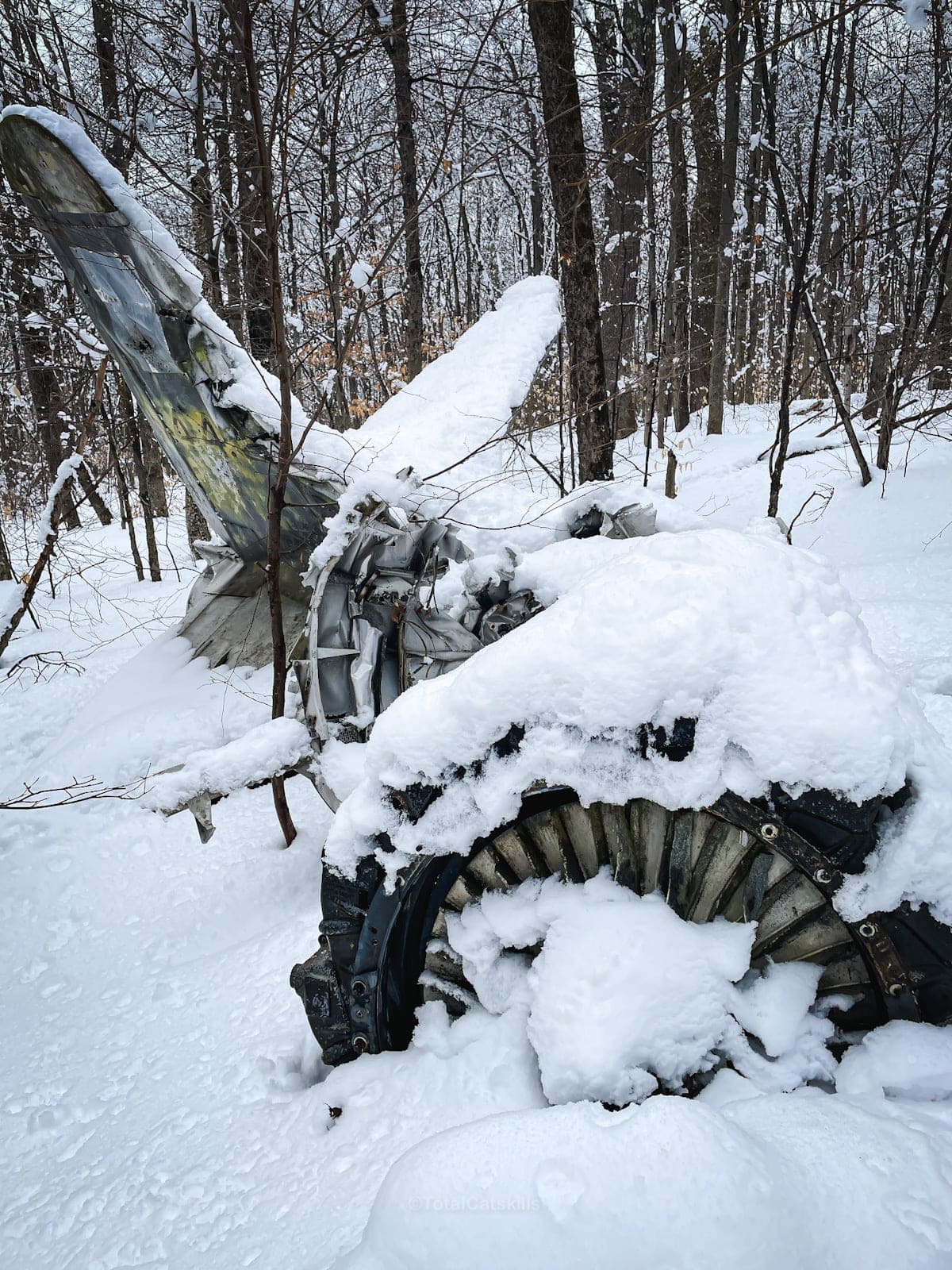 jet engine wreck in winter, covered in snow