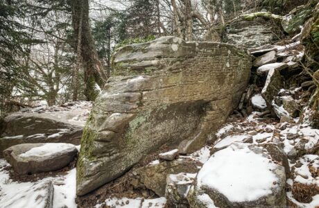 large boulder protruding from mountain