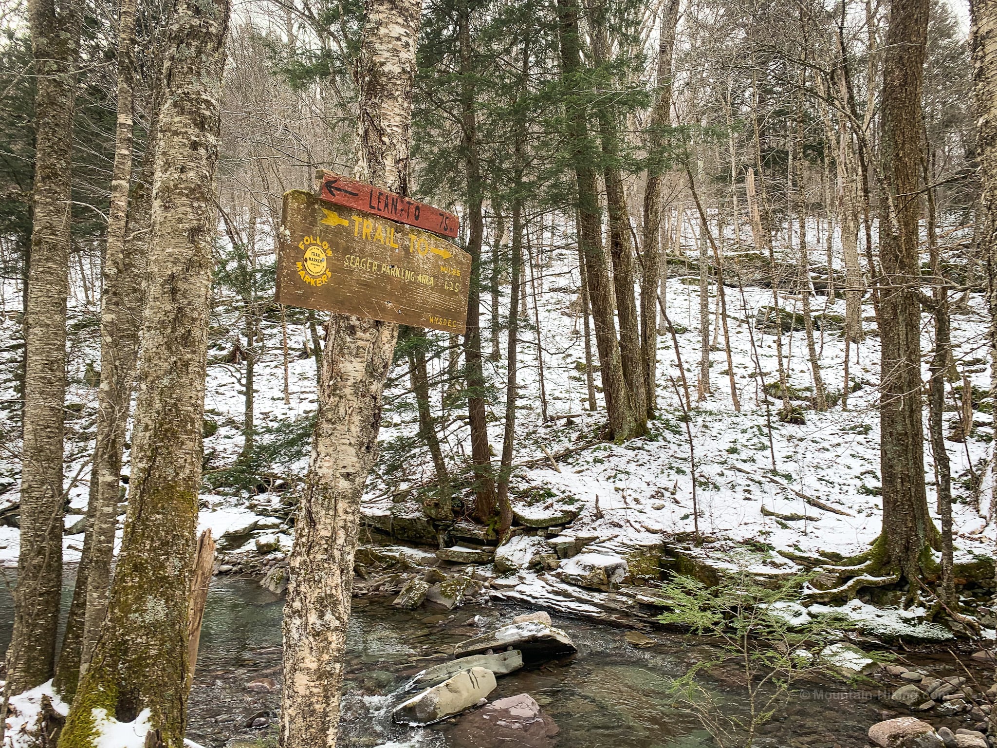 trail signpost beside stream