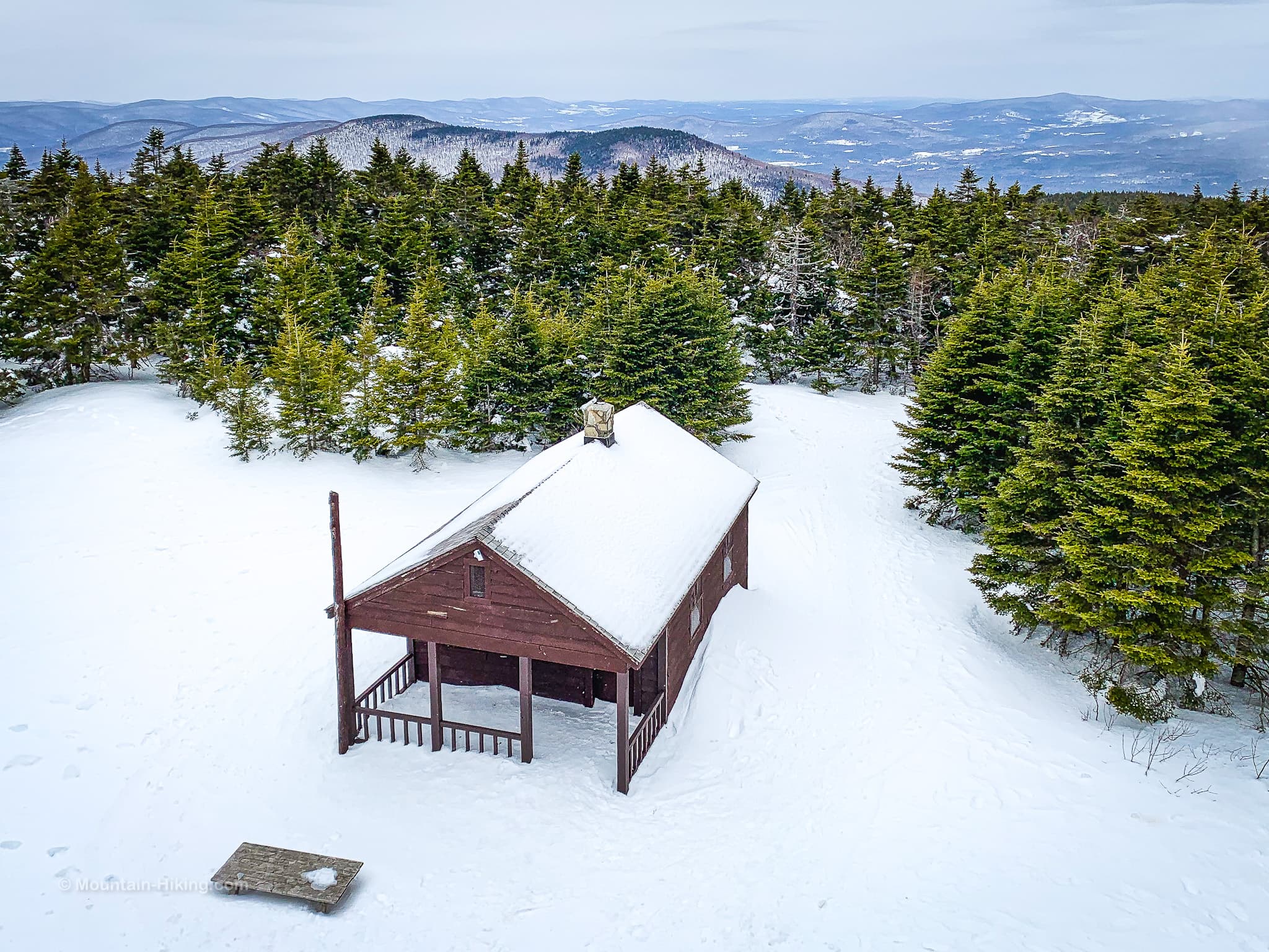 cabin in snow on mountain summit