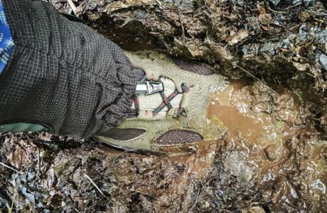 brand new hiking boot stuck deep in mud