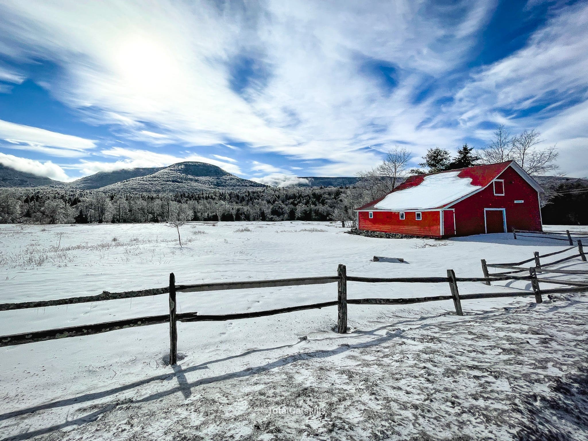 catskills red barn and sugarloaf mountain seen in the snow