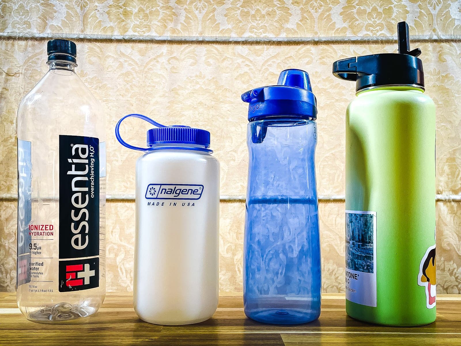 Four kinds of water bottles seen from in front / overconsumption in the outdoors